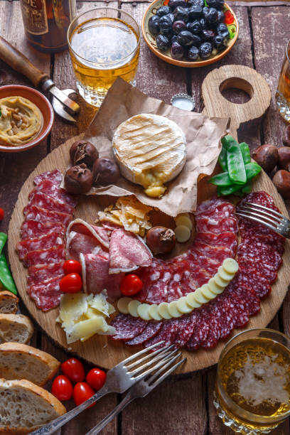 istock Different delicious meat and cheese snacks on wooden board. 906356846