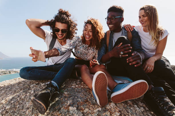 istock Friends on mountain top taking selfie 906359964