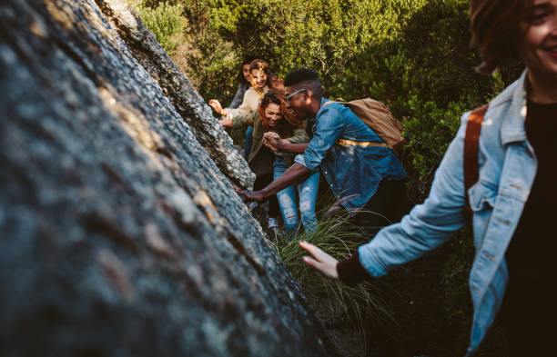 istock Friends walking through a mountain trail 906360028