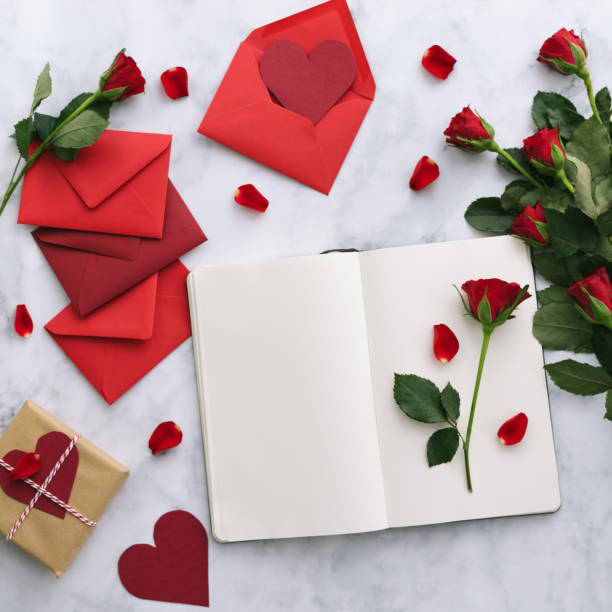 Valentine's Day cards with roses on a marble background Valentine's Day lay out: cards, roses and notepad gift tag note photos stock pictures, royalty-free photos & images