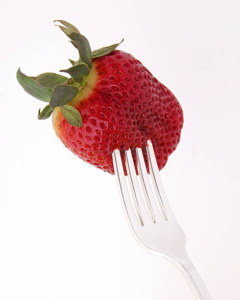 strawberry on fork stock photo