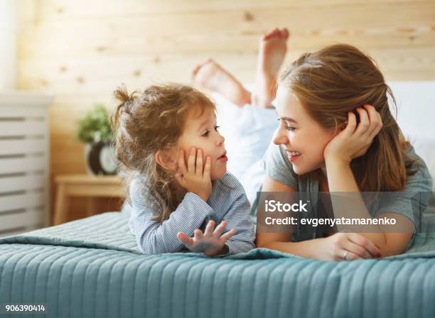 Happy Family Mother And Child Daughter Laughing In Bed Stock Photo - Download Image Now