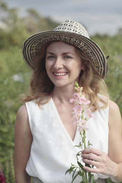 istock Young woman picking flowers at a farm. 906398866
