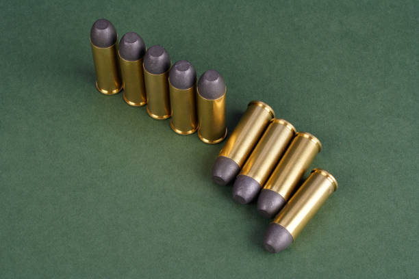 istock Western-style revolver cartridges on green background 906399426