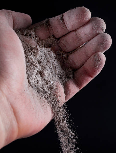 istock Gray ash pour out of human hand 906402284