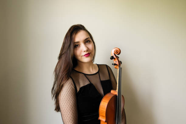 istock Young woman plays viola 906402726