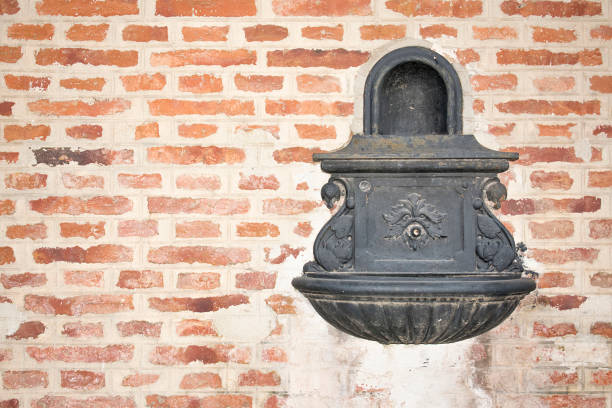 istock Water fountain on a brick wall. 906408258