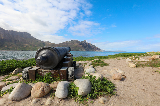 Cannon placed around Hout Bay's fish markets. The cannon pointing towards the mountain gives the photo a direction and provides a different view of Hout Bay.