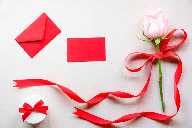 Festive arrangement with gifts and flowers on a table, top view.