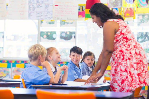 Aboriginal teacher working with children in the classroom.
