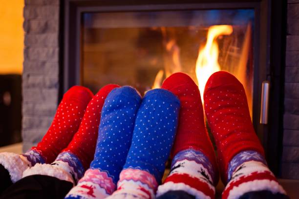 istock Family in woolen sock warming feet 906423060