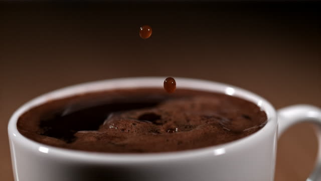 SLO MO Drops of a coffee falling into a cup
