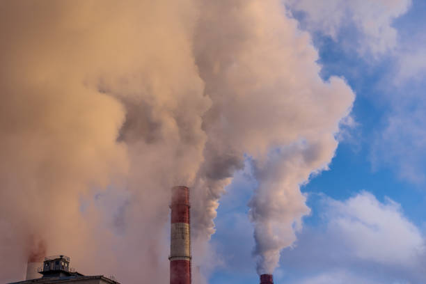 istock industrial smoke from chimneys on blue sky 906462372