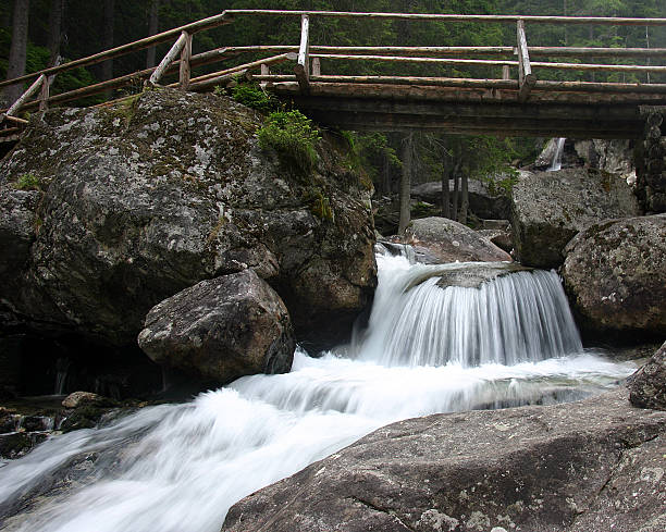 bridge over a waterfall stock photo