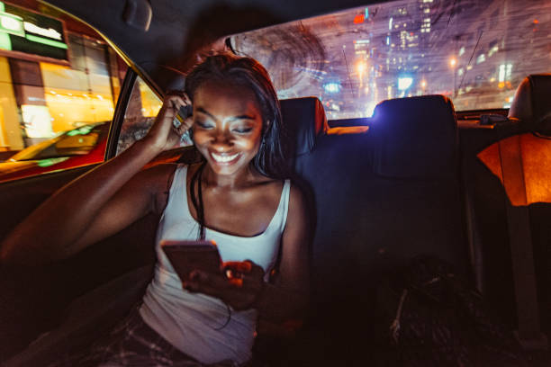 Taxi Ride in New York City African American Woman Commuting by Taxi in New York City. times square manhattan photos stock pictures, royalty-free photos & images