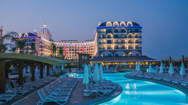istock Luxury resort hotel with Swimming Pool at sunset 906492752