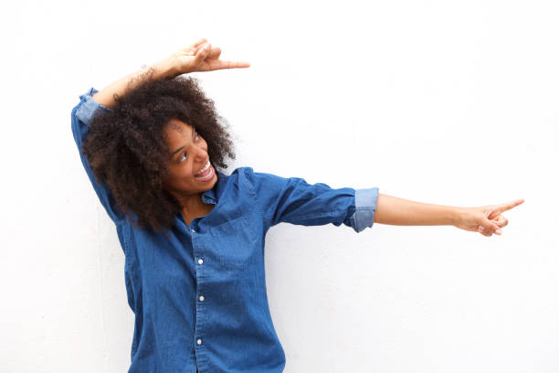 istock smiling beautiful woman pointing to the side against white background 906496342