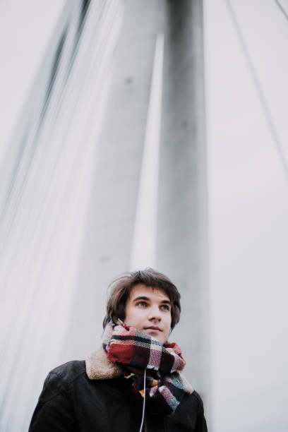 istock Young man enjoying some music outdoors 906506558