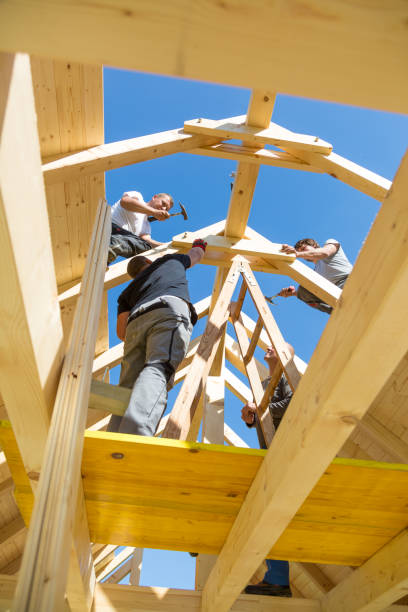istock Builders at work with wooden roof construction. 906506992
