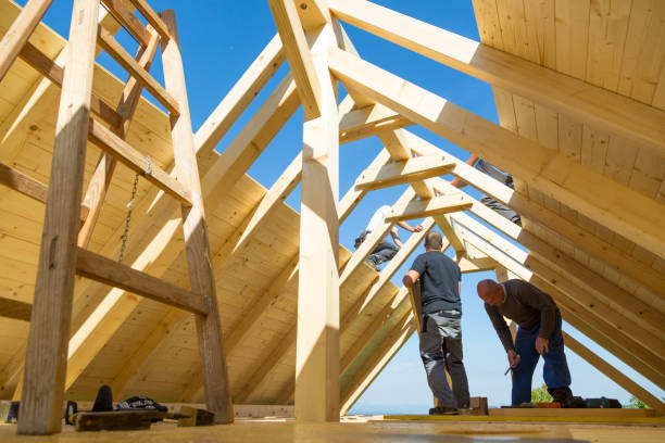 istock Builders at work with wooden roof construction. 906507028