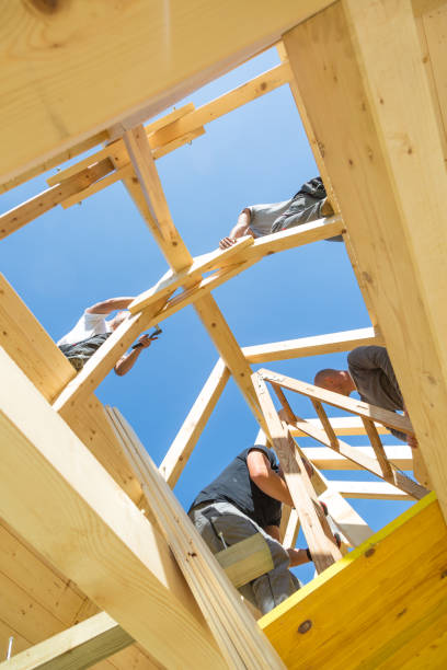 istock Builders at work with wooden roof construction. 906509150
