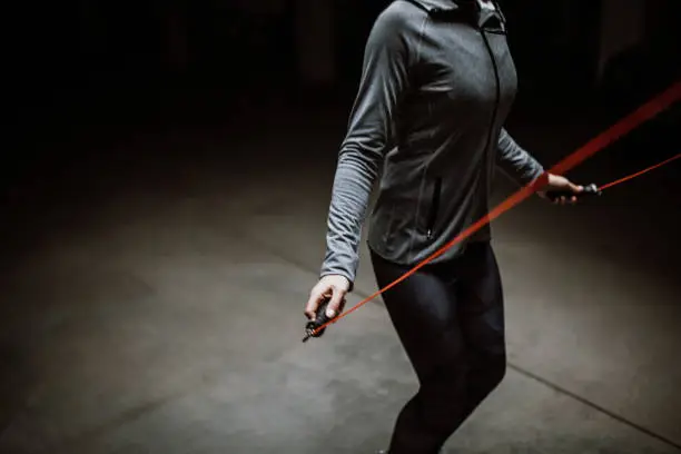 Young athlete skipping rope in underground garage