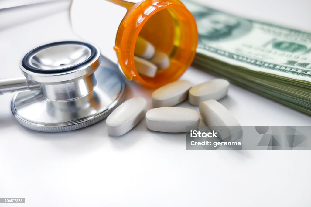 medical expences medicine pills on dollars American Culture Stock Photo