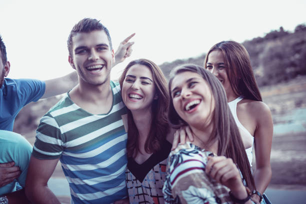 istock Group of Smiling Friends Enjoying a Walk by The River 906519984