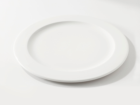 Looking down empty plate on white table