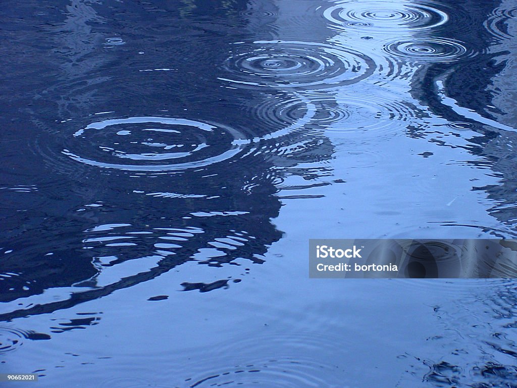 Water ripples Rain drops rippling into a puddle. Rippled Stock Photo