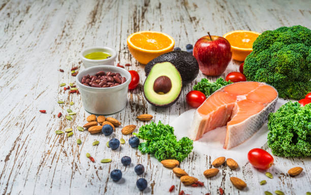 selection of fresh fruit and vegetables, salmon, beans, and nuts. concept of cooking and eating healthy food, fitness, dieting, vegetarian, and lifestyle. ingredients good for heart and diabetes. - diabetes superfoods imagens e fotografias de stock