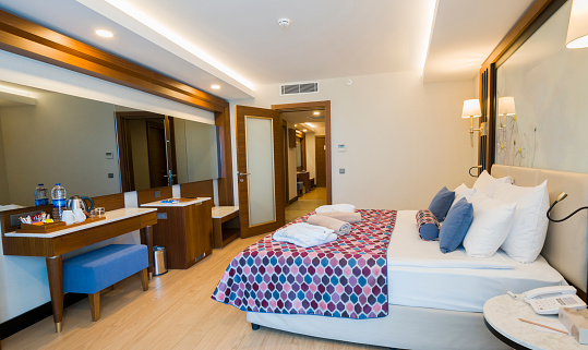 Luxury hotel Bedroom Interior with a Bed.Big comfortable double bed in elegant classic bedroom