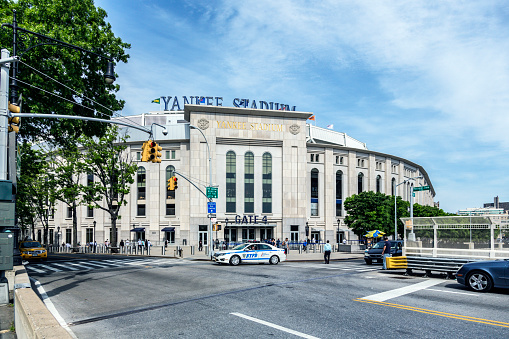 View across 161st street from Macombs Dam Bridge at Yankee Stadium Gate 4 on May 24th, 2015. This newest Yankee Stadium building - opened in 2009 - is the iconic, internationally known home of the major league New York Yankees American League professional baseball team. Located in the Bronx, NY City, New York State, USA.