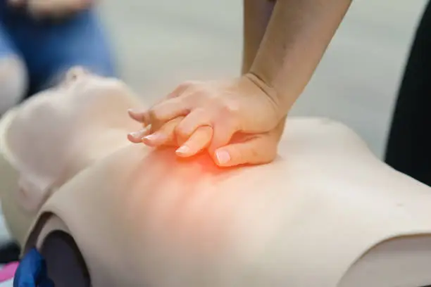 Photo of CPR First Aid Training with CPR dummy in the class