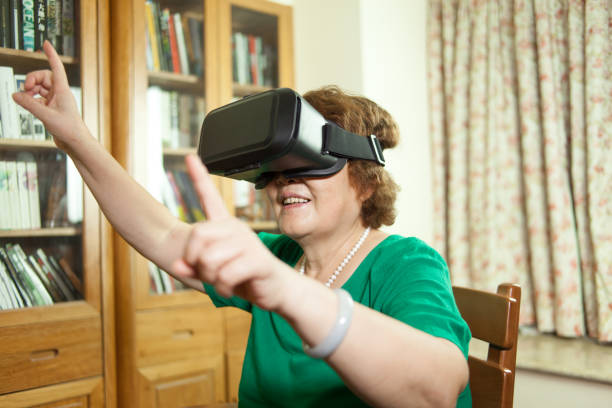 istock Senior woman enjoying VR at home 906542774