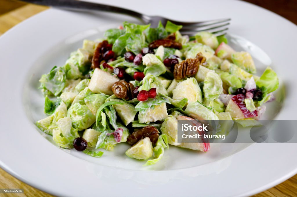 Brussels Sprouts Brussels sprouts, apple and pomegranate with candied pecan salad Brussels Sprout Stock Photo