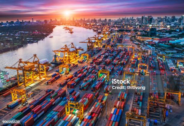 Logistics And Transportation Of Container Cargo Ship And Cargo Plane With Working Crane Bridge In Shipyard At Sunrise Logistic Import Export And Transport Industry Background Stock Photo - Download Image Now