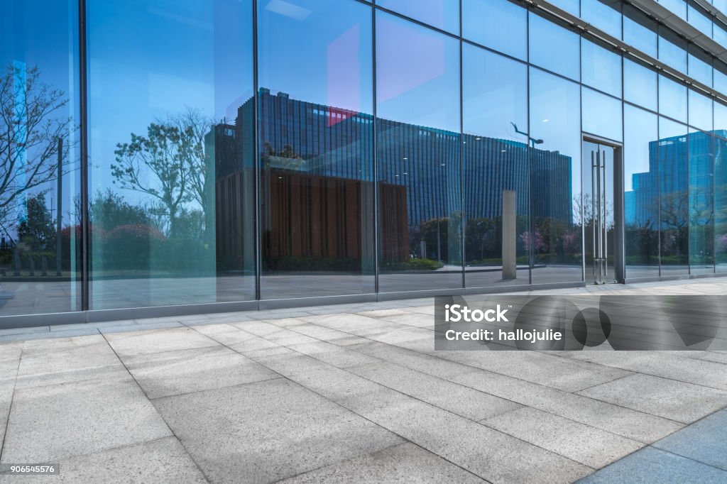 Empty brick road nearby office building Building Exterior, Office Building Exterior, Glass - Material, Construction Industry, Entrance Glass - Material Stock Photo