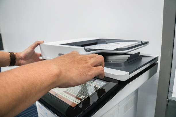 istock close up businessman press on office printer for copying and scanning documents 906551112