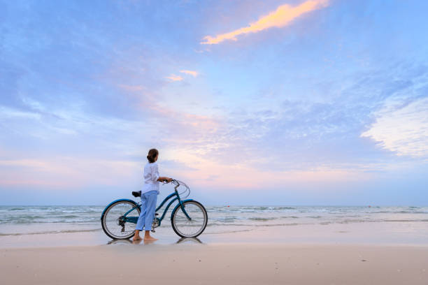 Happy woman with bike on beach Happy woman with bike on beach baltic sea people stock pictures, royalty-free photos & images