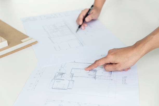 istock Architect working on blueprint, Engineer meeting working with partner colleagues and engineering tools for architectural project, Construction concept 906554226