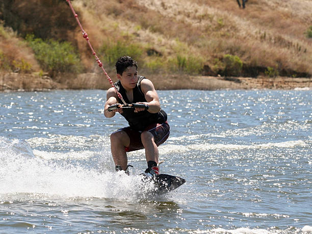 ragazzo wakeboarding - life jacket little boys lake jumping foto e immagini stock