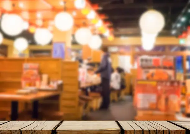 Empty wooden shelf display with Izakaya japanese restaurant background