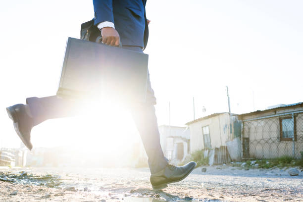 istock Man jumping over dirty stream with suit and briefcase 906564808
