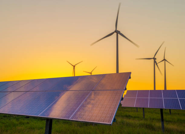 istock Wind generators turbines and solar panels on sunset 906567346
