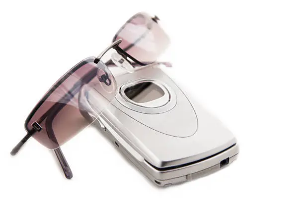 Photo of Cellular Phone and Sunglasses