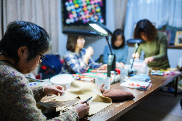 istock Mature women sewing and making crafts together for fun 906575120