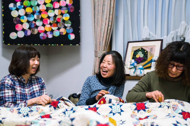 Senior women working together to make a patchwork quilt