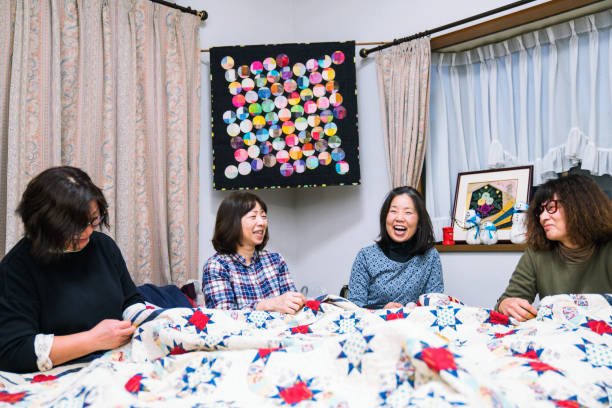 Senior women working together to make a patchwork quilt
