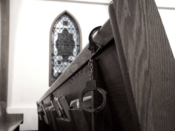 handcuffed, religion - stained glass pew church hymnal stock-fotos und bilder